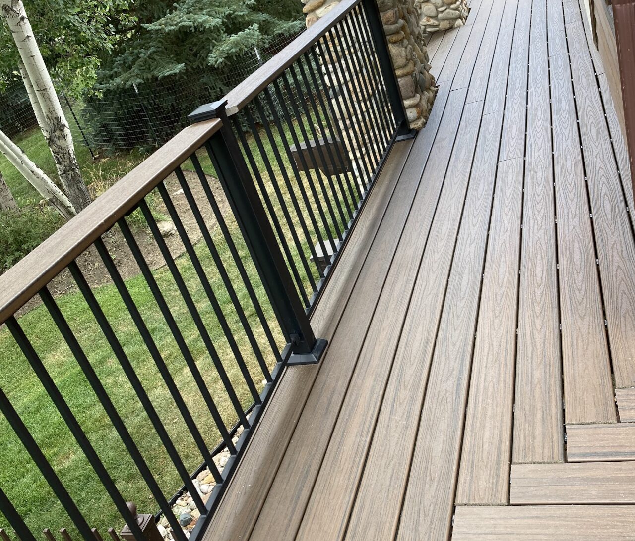 Finished composite deck and metal railing