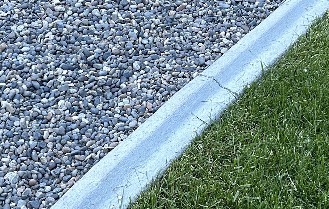Decorative rock border with concrete edging
